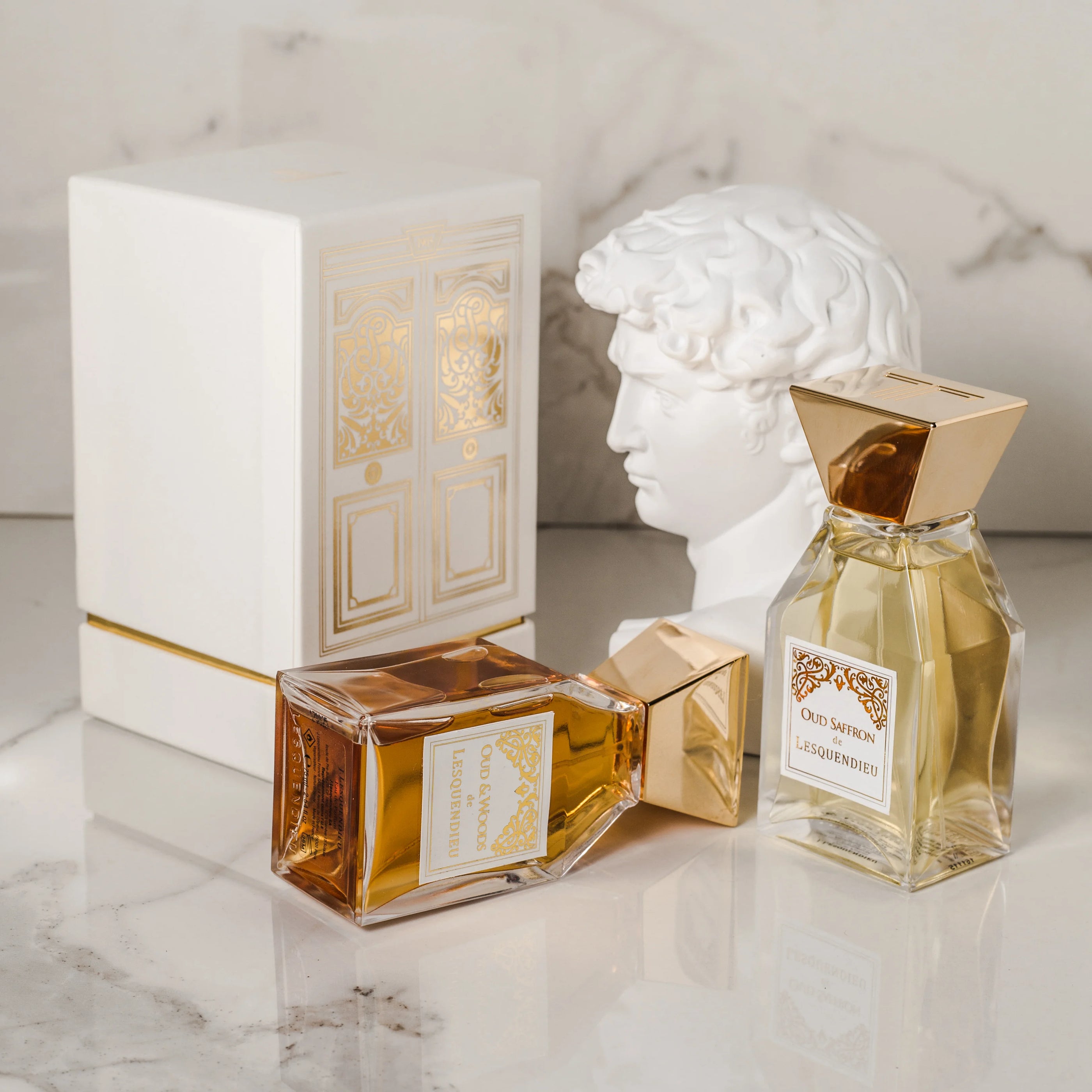 Die zwei Nischendüfte oud woods und oud saffron der Marke lesquendieu aufgestellt neben einer griechischen Büste